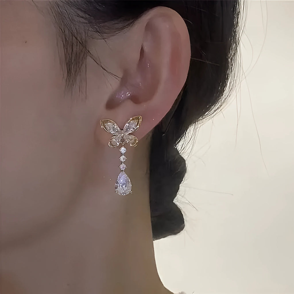 Bow-shaped stud earrings with electroplated platinum finish on zinc alloy