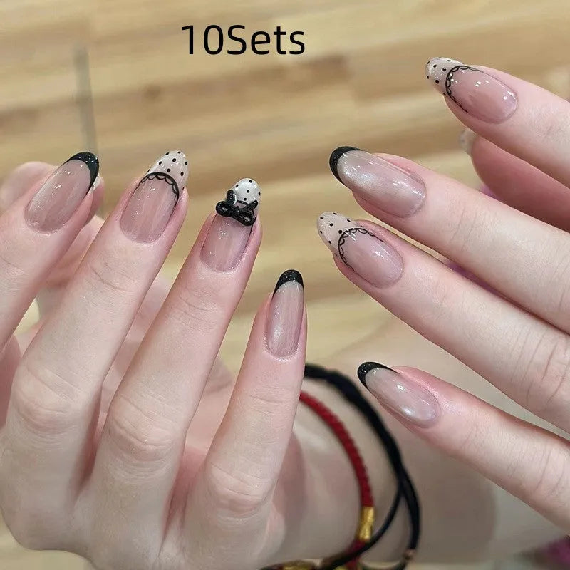 A pack of five pairs of long square-shaped false nails in assorted colours and patterns.