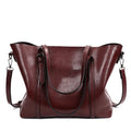 Brown retro messenger bag for women showing front view with strap, 31cm in length.