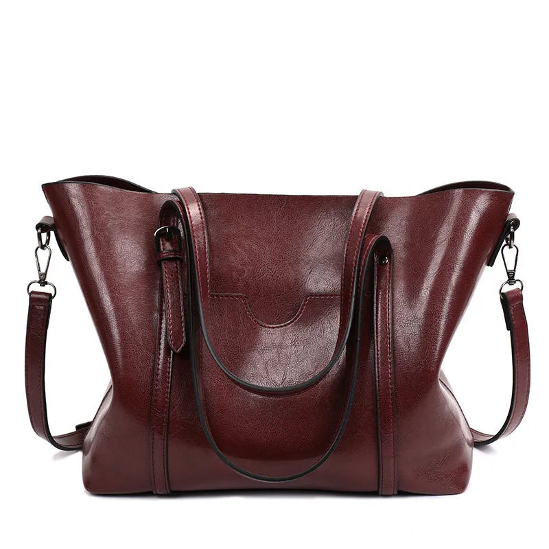 Brown retro messenger bag for women showing front view with strap, 31cm in length.