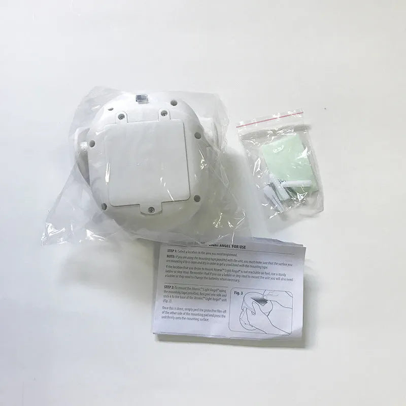 White Atomic Angel induction light with dimensions 13.3cm by 9.8cm by 15.8cm