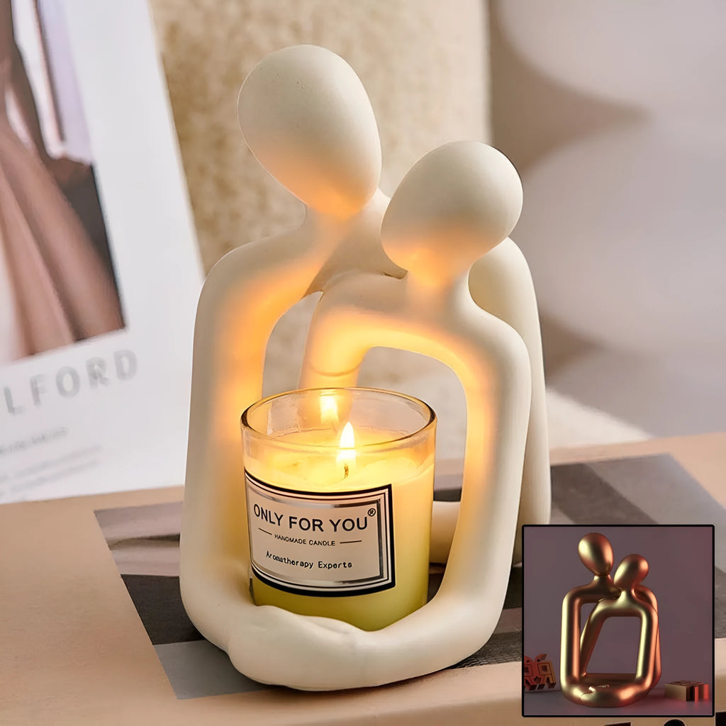 Modern minimalist loving couple resin statue in milky white or gold finish on a desk.