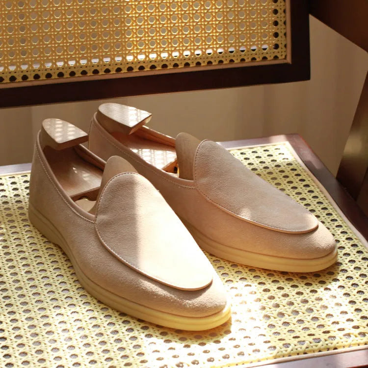 Men's brown genuine leather British handmade loafers on a white background.