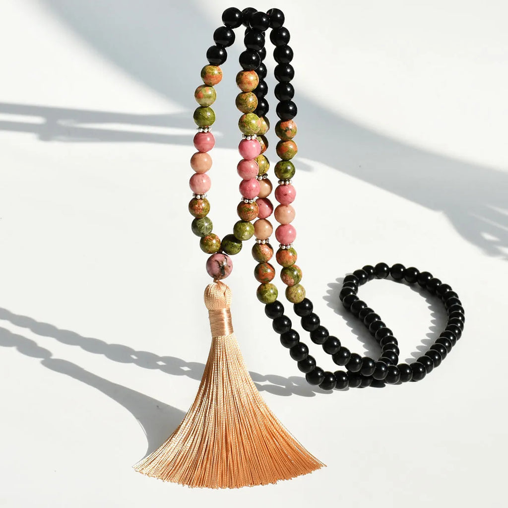 Long bohemian necklace with 108 stone tassels and a geometric gemstone pendant on an 81cm chain.