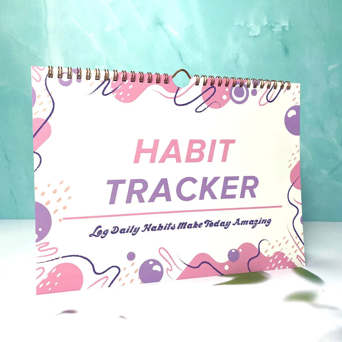 Habit tracking book with 12 pages showing colour options and 21x28cm size