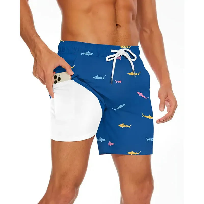 Man wearing loose grey polyester beach shorts on a sandy shore
