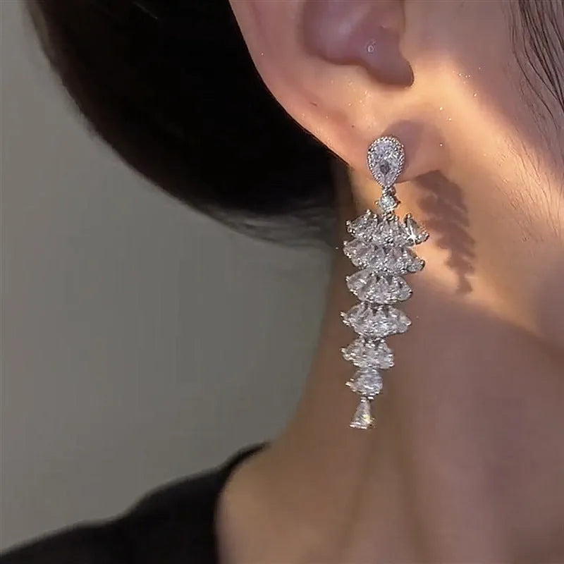 Women's silver pagoda Christmas tree drop earrings with a dangling zircon star on copper studs.