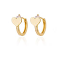 Gold and clear heart-shaped clip-on earrings with a zircon stone on a white background.