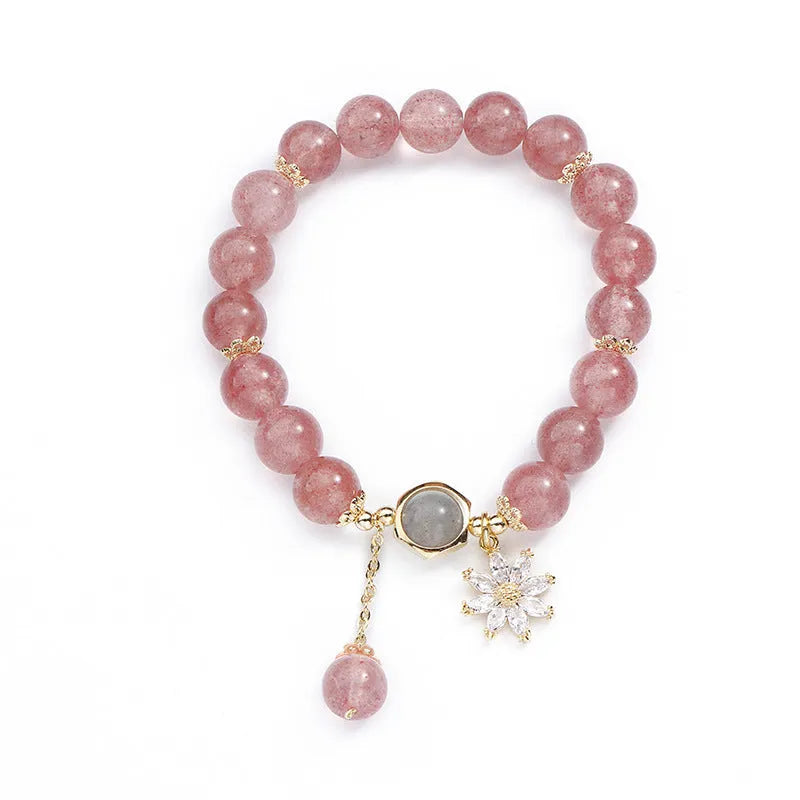 Strawberry quartz Mori style bracelet with electroplated floral details on a white background