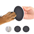 Round blue dog nail file board with an ergonomic handle on a table.