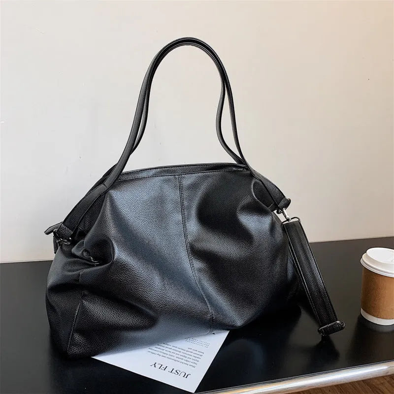 Large soft surface messenger bag in horizontal square shape with adjustable shoulder strap