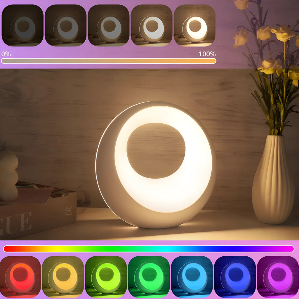 Small RGB colour changing desk lamp with remote control on wooden surface