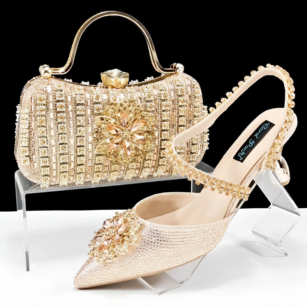 Women's black high heel ankle strap sandal with rhinestone flower and matching clutch bag.