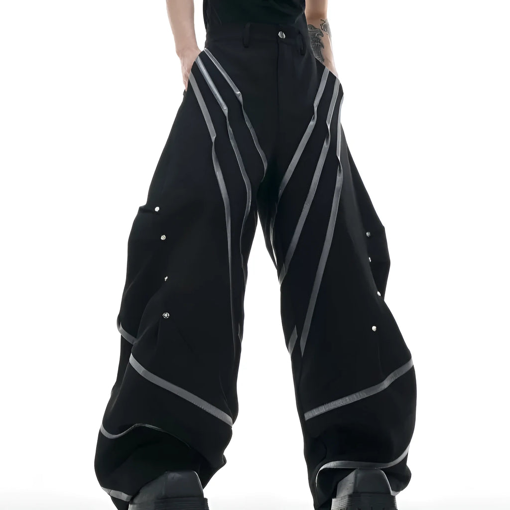Men's black trousers with metal striped rivets and pleated design detail