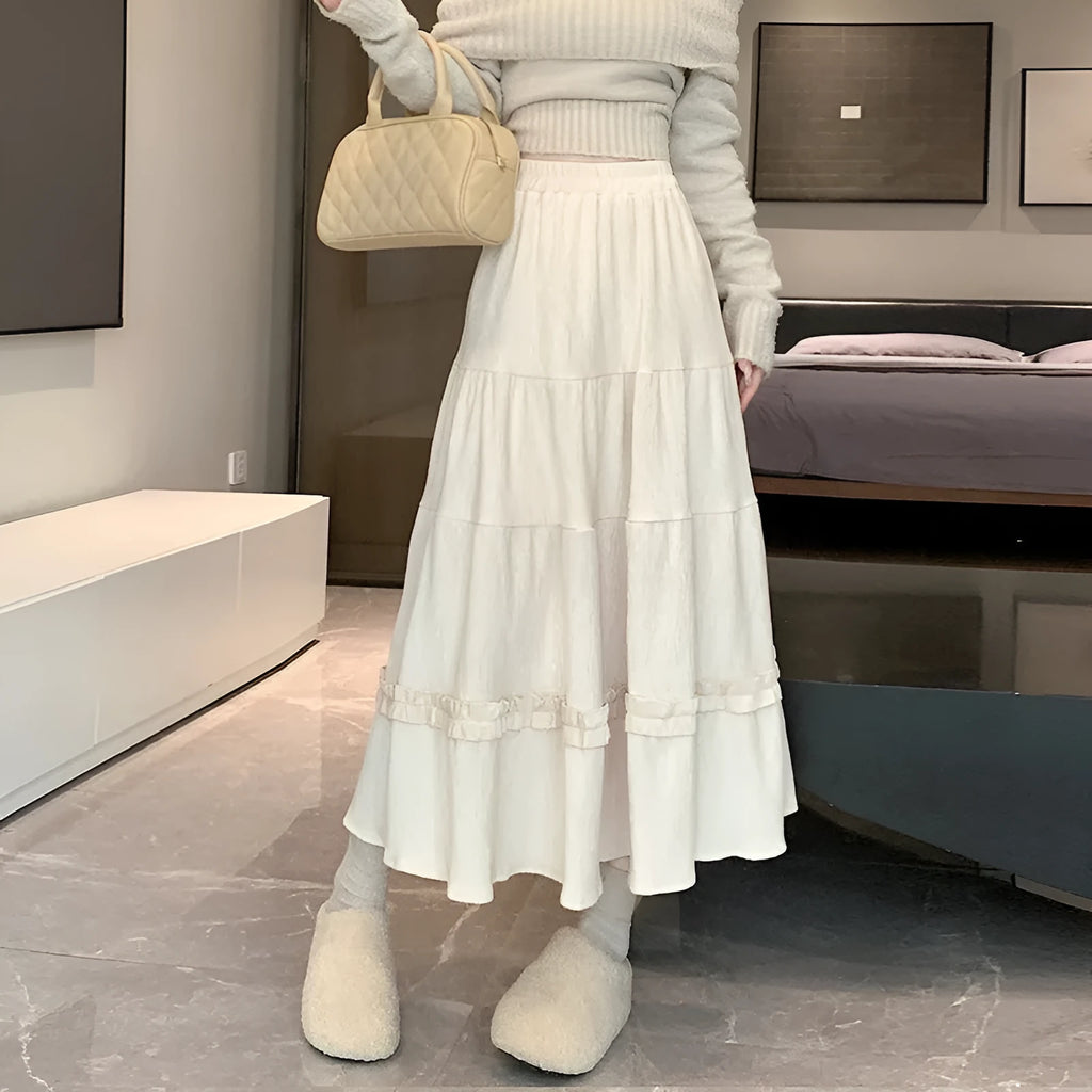 Korean-style beige corduroy A-line midi skirt with an elastic waistband laid flat.