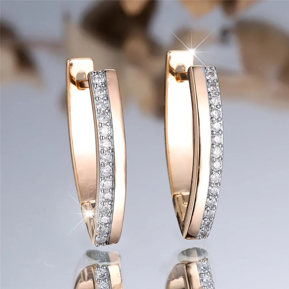Geometric V-shaped women's earrings in champagne gold white diamond colour.