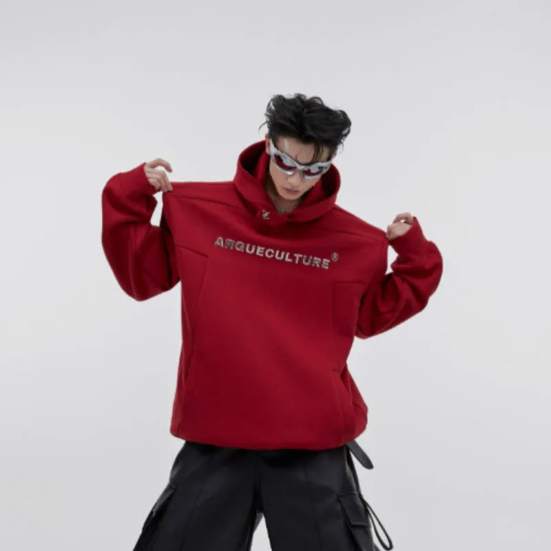 Red men's loose-fit hooded sweater with heavy shoulder pads and a metallic 3D printed design on the front.
