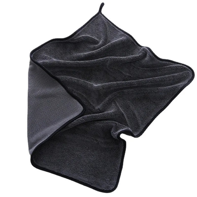 Grey automobile cleaning cloth with black edging showing spiral hair texture and hemmed edges