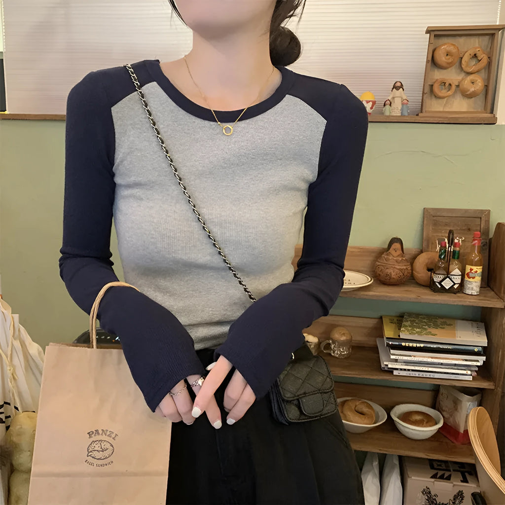 Women's dark blue viscose top with long princess sleeves and embroidery detail on front.