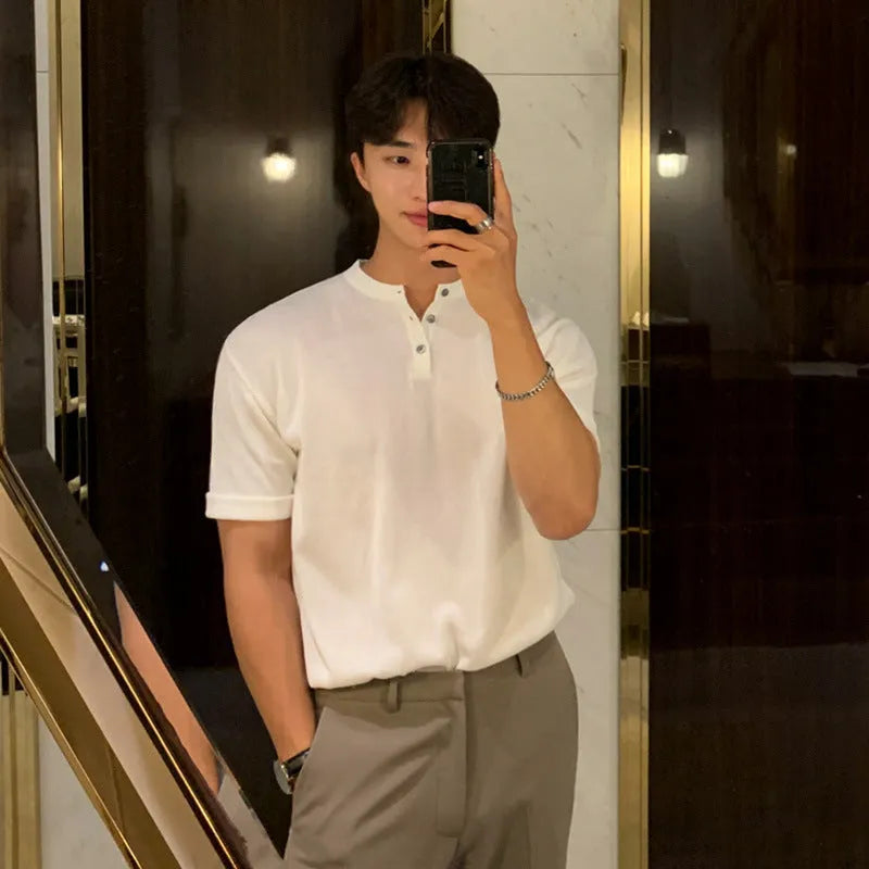 Man wearing a thin black short-sleeved ice silk knitted pullover shirt with a slim loose fit.