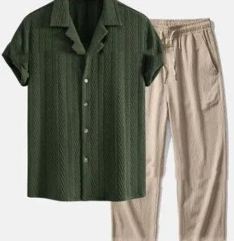 Man wearing a loose blue short sleeve shirt and matching trousers from a milk silk polyester summer suit set.