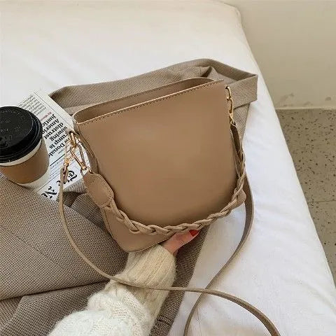 Retro-inspired woven PU crossbody bucket bag in khaki colour showing androgynous design details