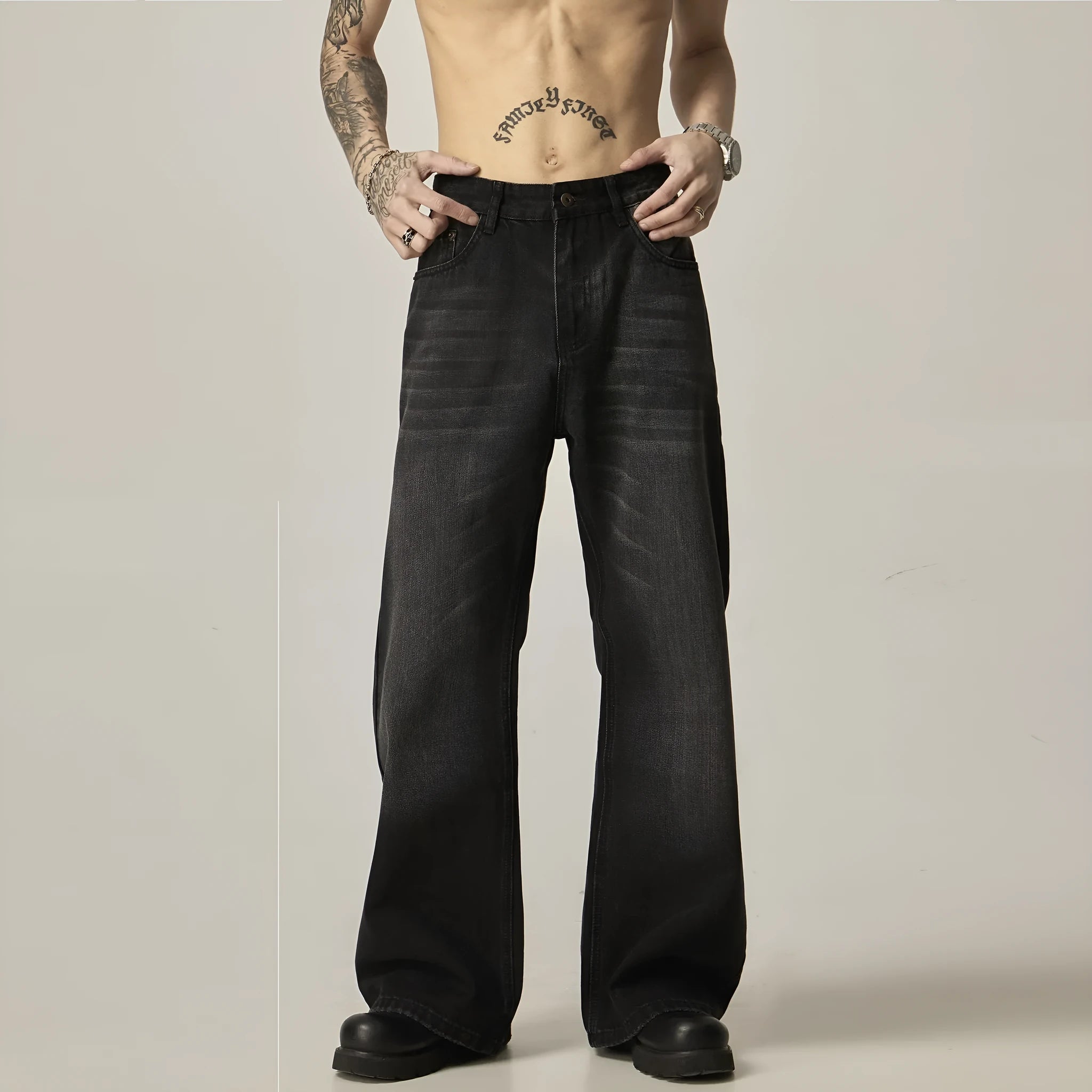 Black loose fit straight leg retro jeans on a hanger, showing zipper fly and relaxed silhouette.