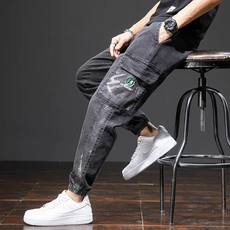 Man wearing grey-blue straight leg cargo jeans with micro elasticity and cargo pockets.