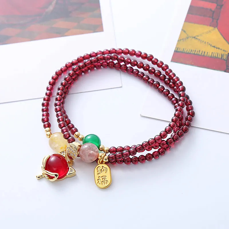 Purplish red garnet fox bracelet with adjustable rope closure and nature-inspired charm
