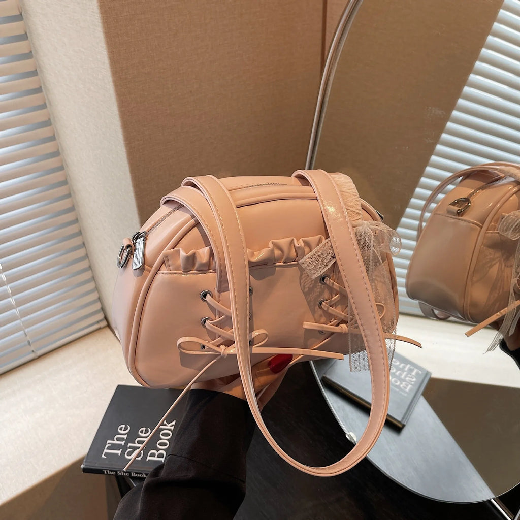 Women's casual shoulder bag in PU leather with a white bandage bow design on the front.
