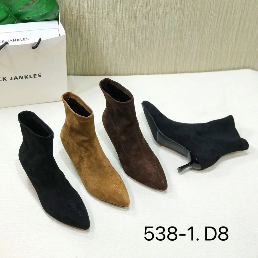 Black pointed toe ankle boots with high stiletto heel and mid-calf shaft showing microfiber texture