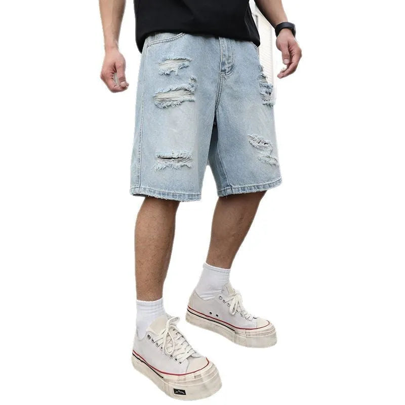 Light blue distressed denim shorts with ripped detailing and loose casual fit