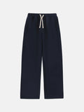 Men's black loose-fit fleece-lined sweatpants with an elastic drawstring waistband laid flat.