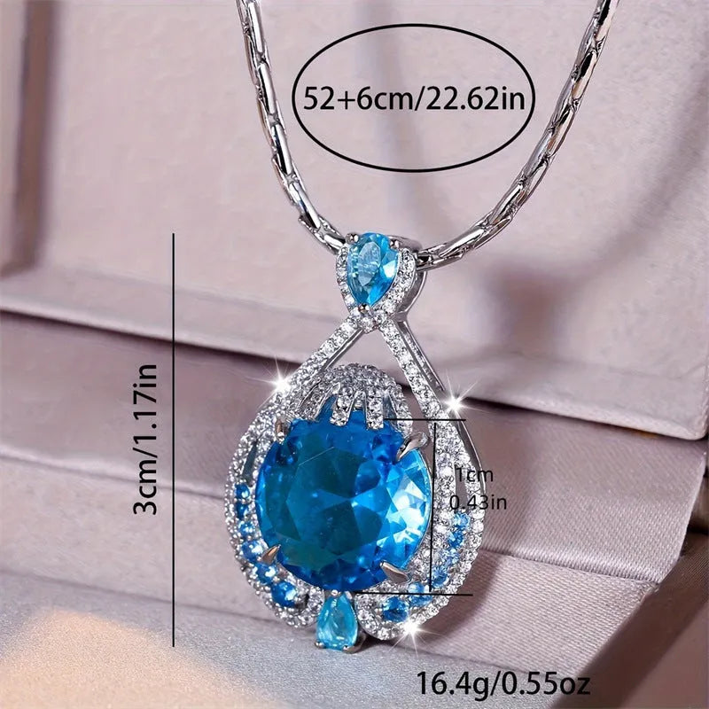 Blue geometric crystal pendant necklace on a water wave chain for women.