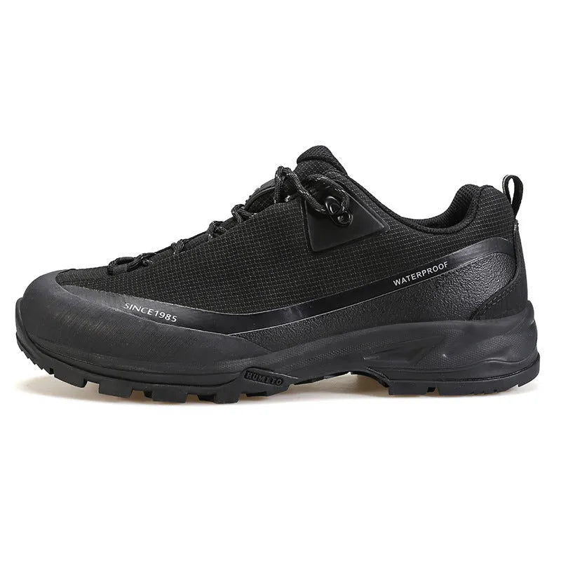Men's low-top mountain climbing shoes in black with non-slip rubber soles and lace-up front closure