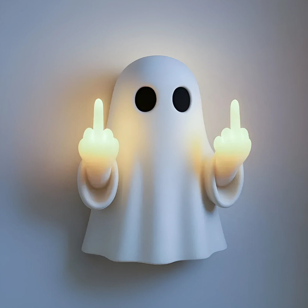 Small white ghost-shaped plastic night lamp for Halloween decoration on a table.