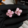 Close-up of gold plated purple oil-spot glaze flower stud earrings on copper base with needle post