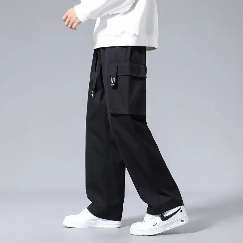Boys' straight leg cargo pants in army green with large pockets and a drawstring waistband.