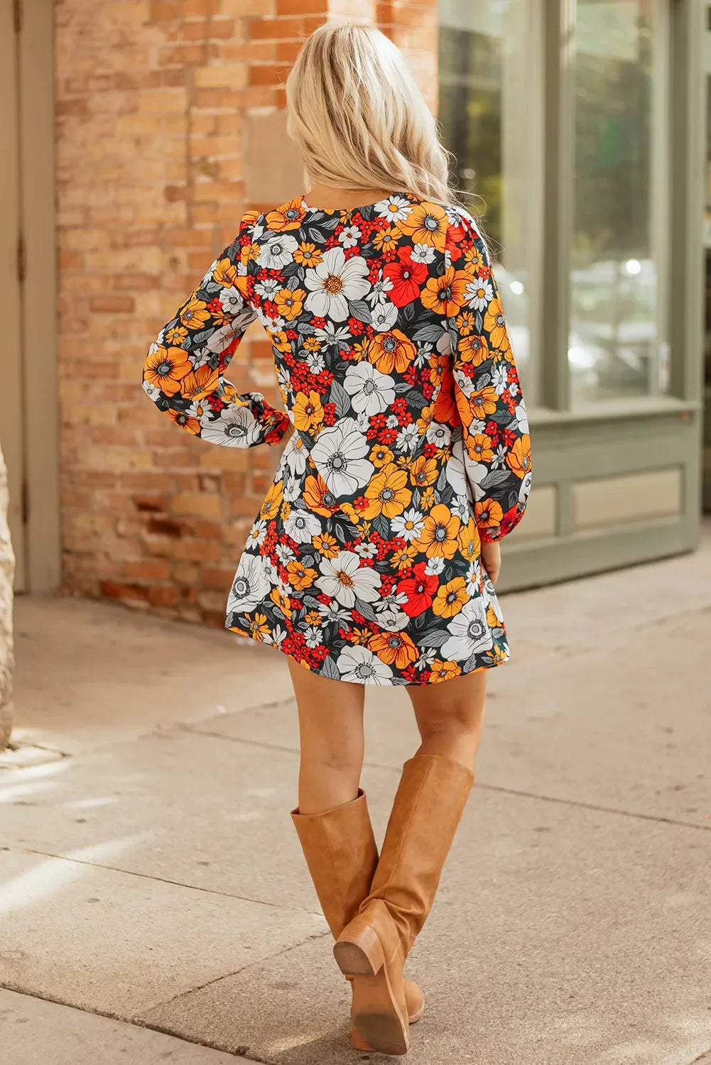 Orange floral and striped print mini dress with lace trim, long sleeves, and a V-neck.