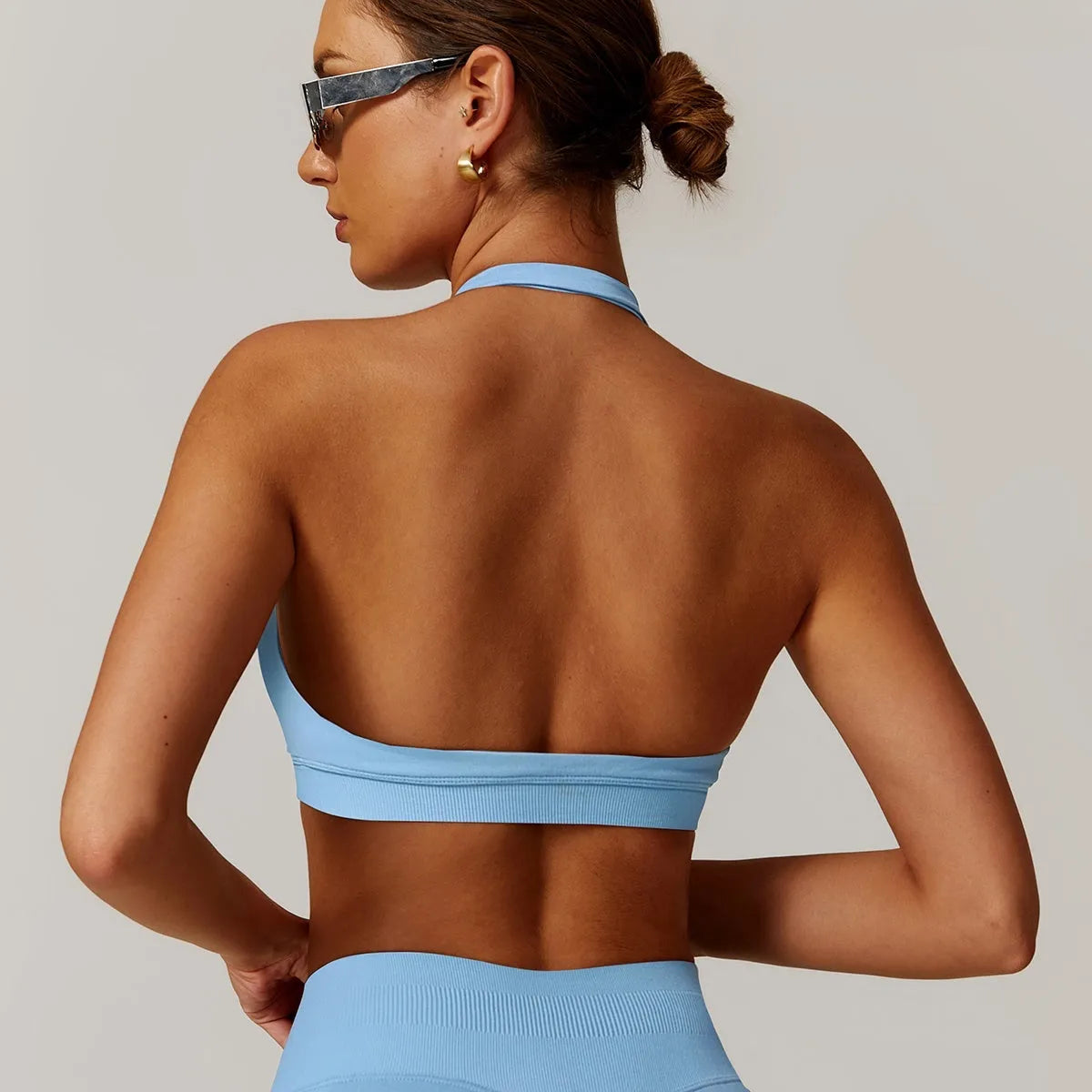 Women's halter style yoga sports bra in nylon fabric with removable padding