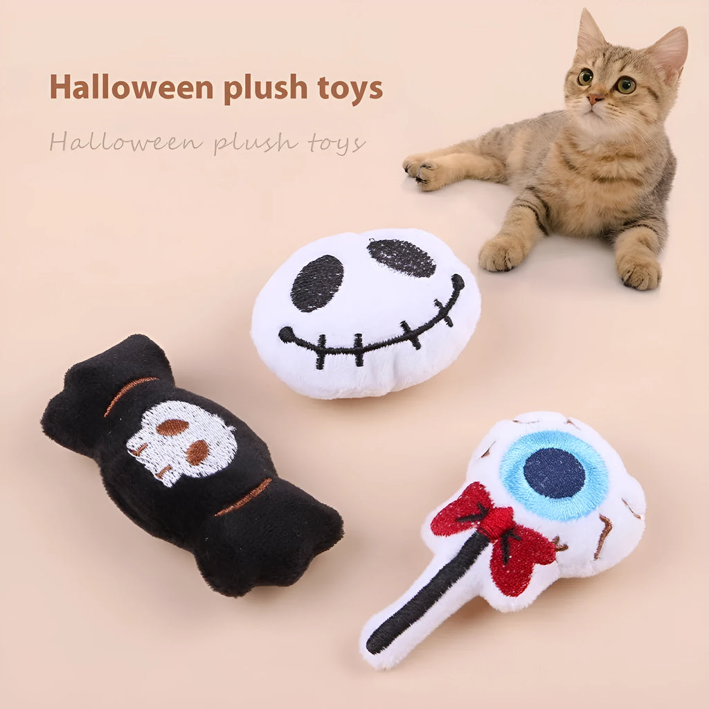 Small plush cat teaser wand toy showing candy, skull and eye patterns on soft fabric