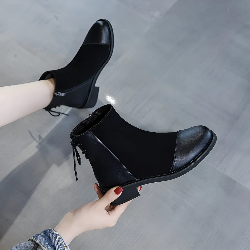Women's black knee-high Martin boots with side zipper, round toe, and short stout heel.