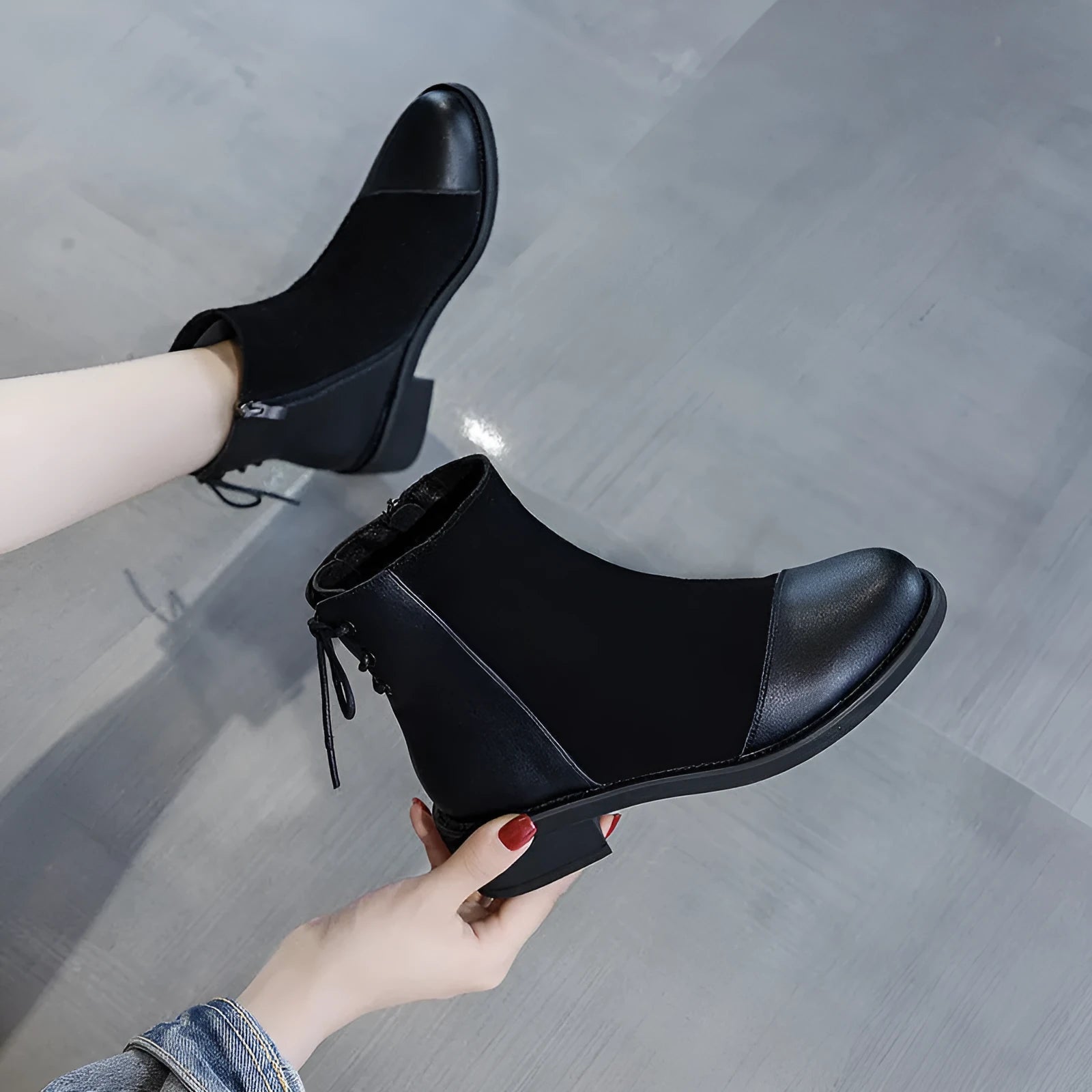 Women's black knee-high Martin boots with side zipper, round toe, and short stout heel.