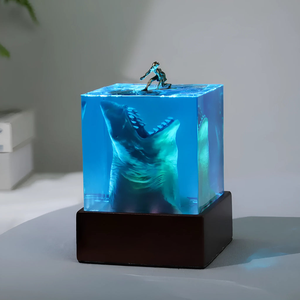 Clear epoxy resin ornament with shark surfing on a wave, includes lamp holder.