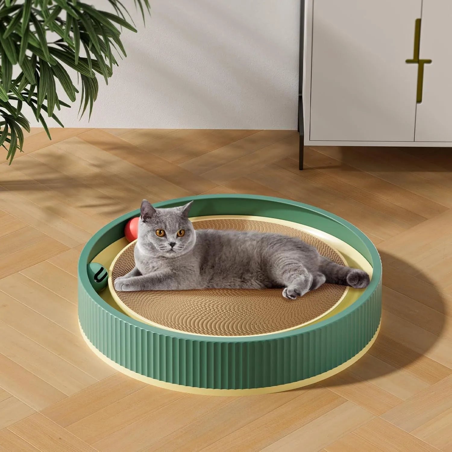 Large green circular cat scratching board with replaceable core and integrated ball toys