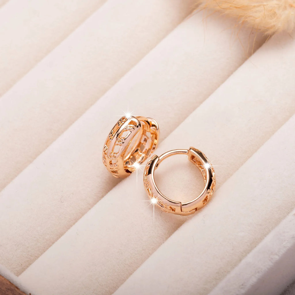 Rose gold finished leaf-shaped hollowed-out earrings with heart detail on copper base