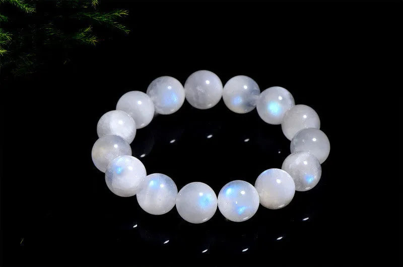 Natural blue moonlight round bead moonstone bracelet showing polished geometric beads on wrist