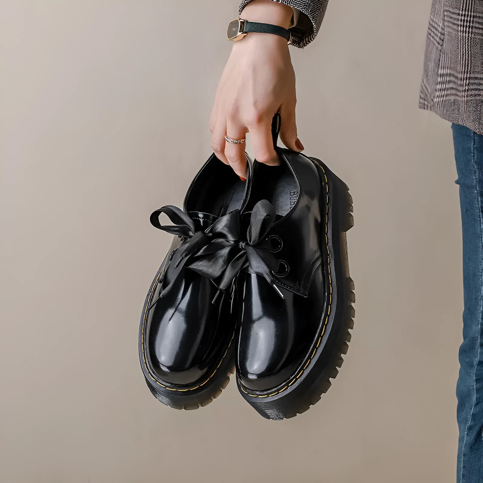 Black and white thick soled women's lace-up shoes with cross straps on a superfine fibre upper.