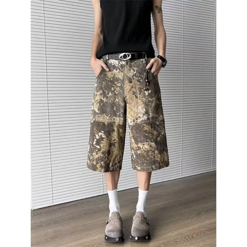 Yellow women's cropped jeans with a bold snake and camouflage pattern print on the legs.