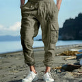 Men's loose linen trousers with ankle tie closure in army green colour.